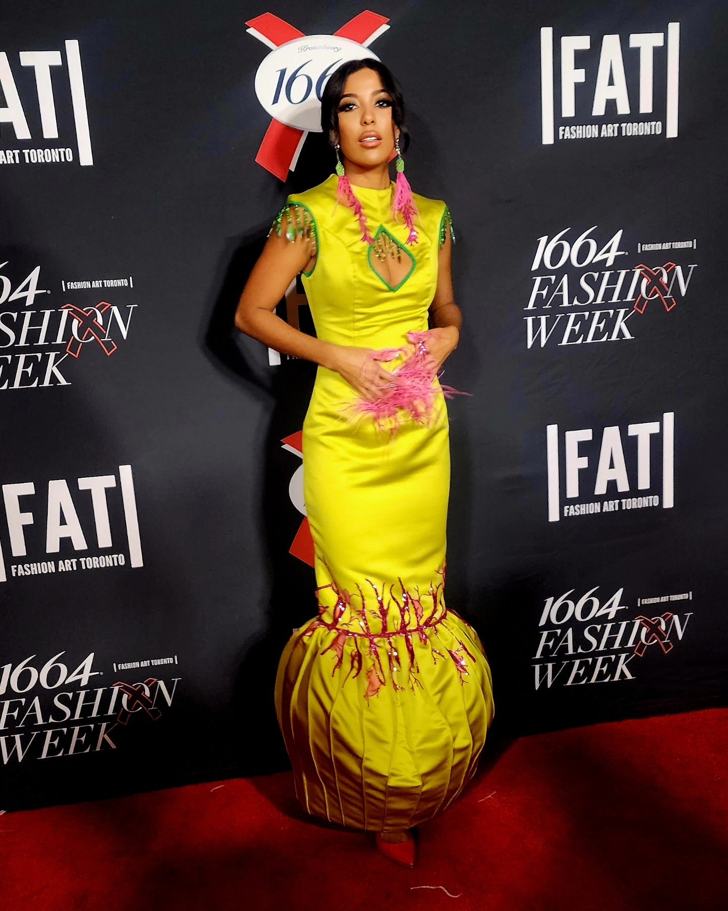 Chartreuse feathered gown on the carpet