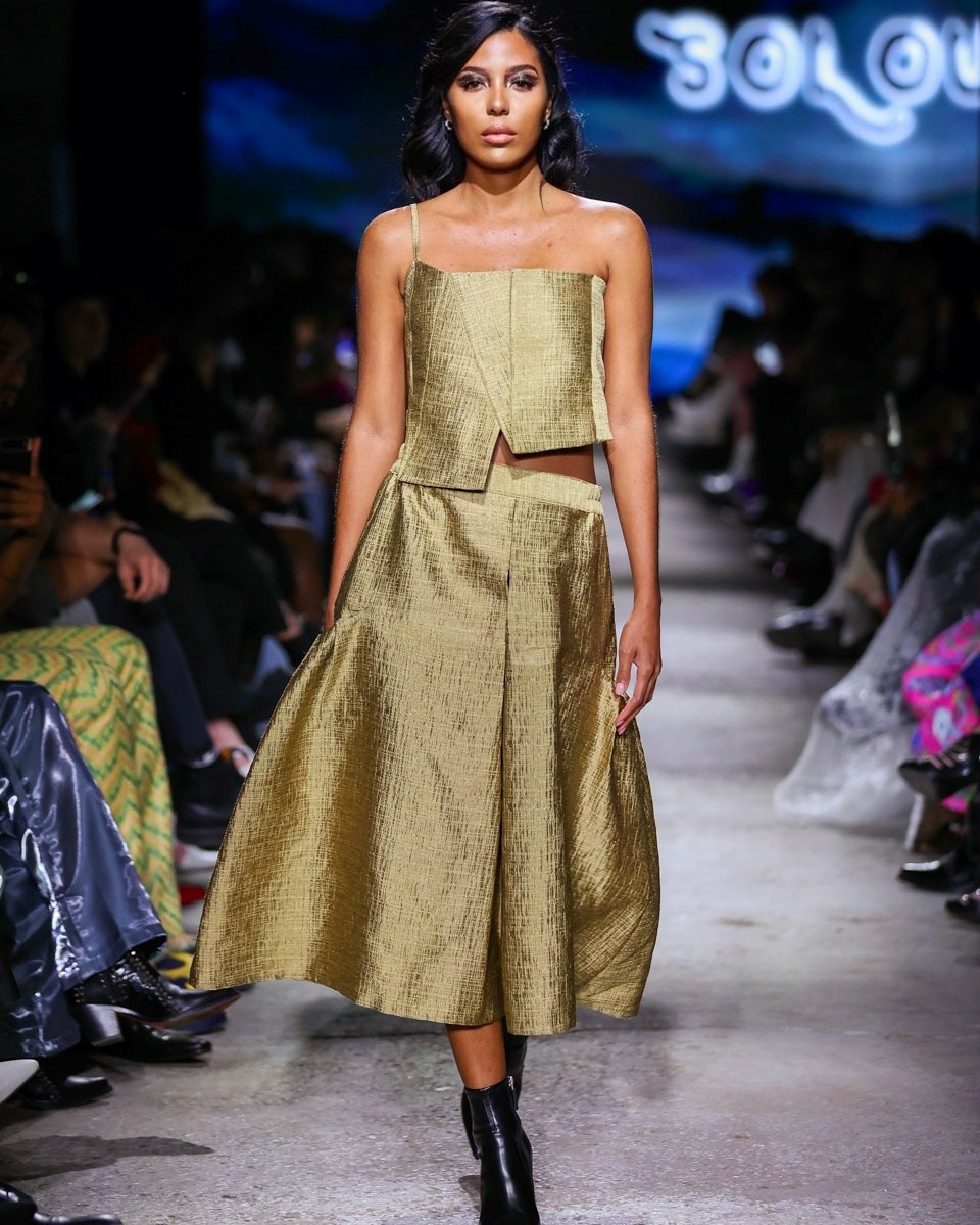 Olive metallic look in motion on runway